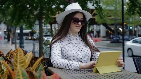 Happy female is talking using video connection on tablet pc Stock Footage 104314482