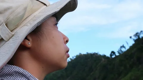 Happy female traveler with backpack standing on mountain enjoying nature. Stock Footage 196277953