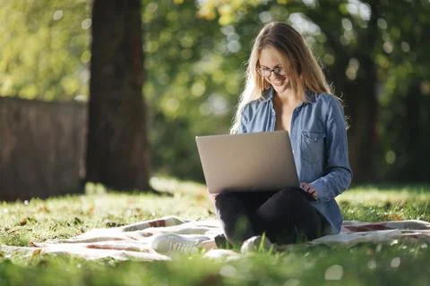 Happy female using laptop for work on fresh air Foto stock