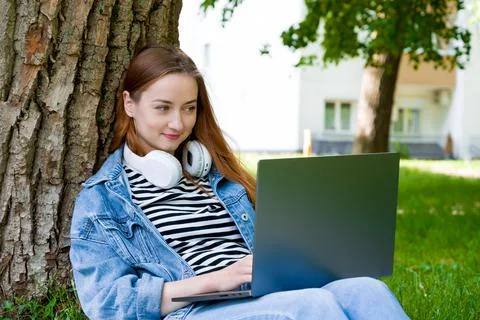 Happy female using laptop for work or education in the parl.Remote edication  Stock Photos