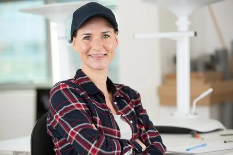 Happy female worker after assembling a chair Stock Photos