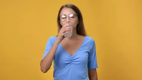 Happy feminine drinking refreshing clear water beverage having health balance Stock Footage 162094076