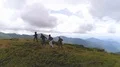 The happy four people dancing on a mountain top with the beautiful view 4k or 4k+ Resolution