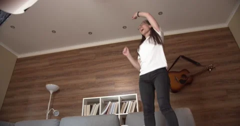 Happy freelancer / student jumping on bed at home . Student Stock Footage 133368401