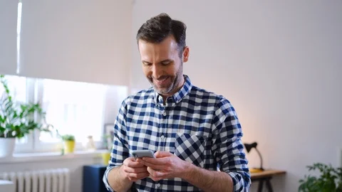 Happy freelancer using smartphone while working from home 動画素材 126824233