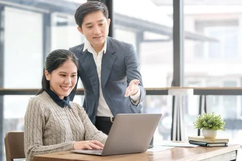 Happy friendly business team using laptop, working together on a new projec.. Stock Photos