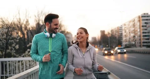 Happy friends and sports people jogging and running outdoor Stock Footage