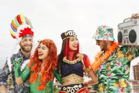 Happy friends celebrating carnival party outdoor Stock Photos