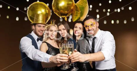 Happy friends clinking champagne glasses at party Stock Photos