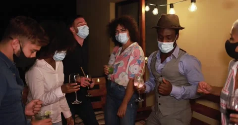 Happy friends dancing and drinking cocktails at home party Stock Footage 141049404