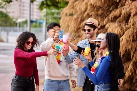 Happy friends drinking while partying outdoors. Fotos Stock