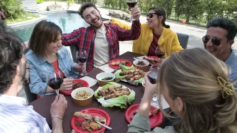Happy friends having fun at pool terrace drinking red wine Stock Footage 198064320