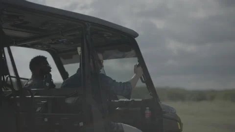 Happy Friends Jamming to Music While Driving ATV Off Road Vehicle Outdoors Stock Footage 323403958