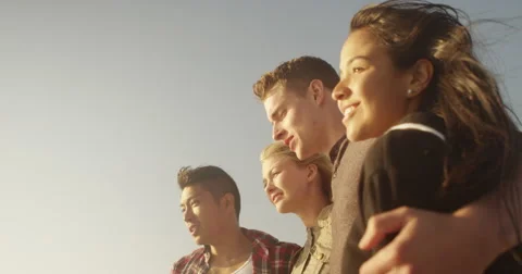 Happy friends looking at the ocean talking Stock-Footage 51789652
