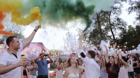 Happy friends making wedding party,throwing confetti and using colorful smoke Video stock 84338796