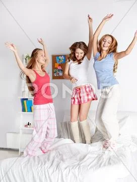 Happy friends or teen girls having fun at home Stock Photos