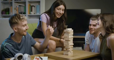 Happy friends playing table games at home Stock Footage 297789536