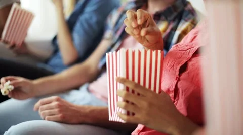 Happy friends with popcorn watching tv at home Stock Footage