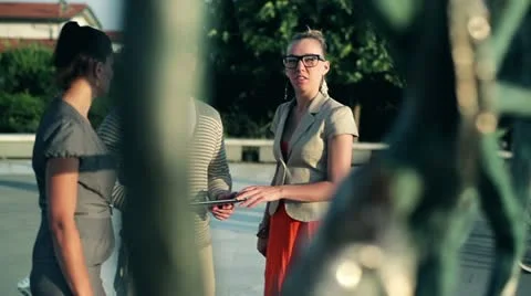 Happy friends with tablet computer looking at sculpture and talking, outdoors Stock-Footage 12554232