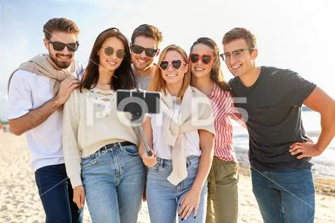 Happy friends taking selfie on summer beach Stock Photos