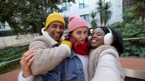 Happy friends taking selfie in winter city Stock Footage 297064241