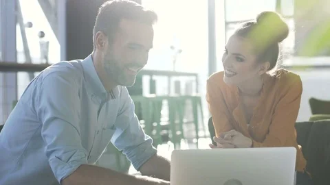 Happy friends using laptop at cafe laughing Stock Footage 70809216