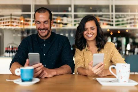 Happy friends using mobile. Stock Photos