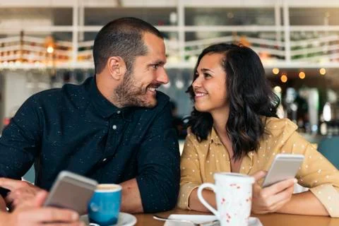 Happy friends using mobile. Stock Photos