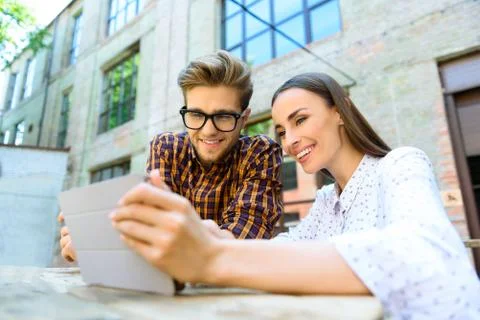 Happy friends using modern technology Foto stock