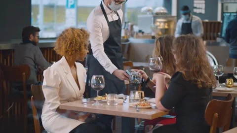 Happy friends using phone making contactless payment in restaurant before Video stock 141475803