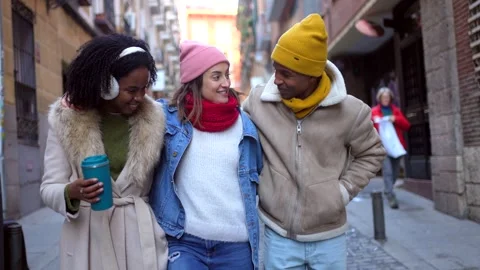 Happy friends walking and talking in winter city Stock Footage 297064155