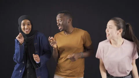 Happy fun and cute three multiethnic friends dancing having fun, laughing. Stock Footage 228848797