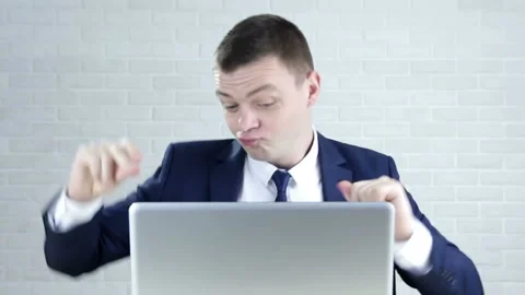 Happy, funny businessman with laptop dancing by desk in office Stock Footage