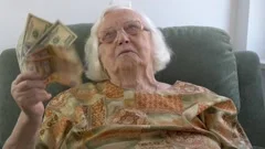 Happy, funny old lady is holding cash | Stock Video | Pond5