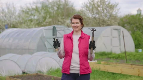 Happy gardener posing with tools Stock Footage 153993283