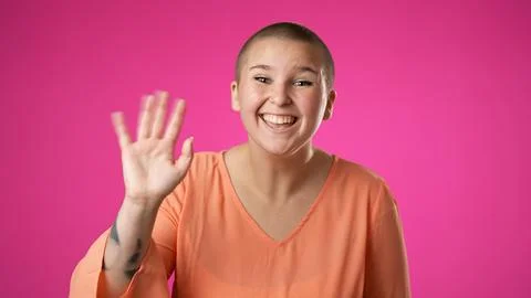 Happy gender fluid non binary young woman 20s video chatting, as seen from the Stock Photos