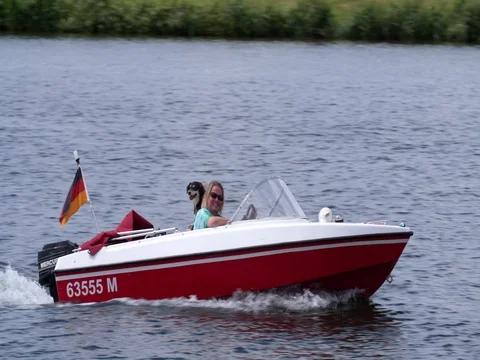 Happy German middle aged couple sailing speedboat Stock Footage 77184986