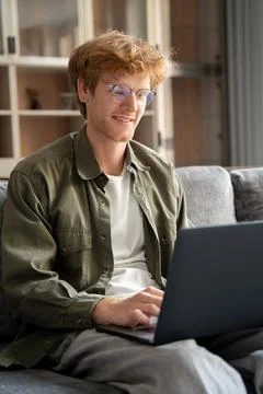 Happy ginger british man using laptop for chatting in virtual video chat Stock Photos