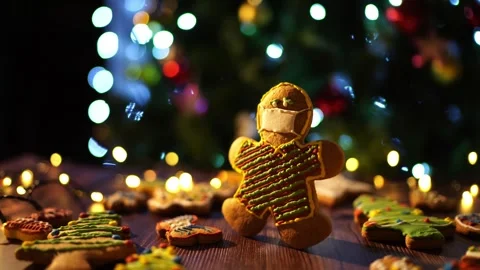 Happy gingerbread man on table in front of Christmas tree Stock Footage 270231978