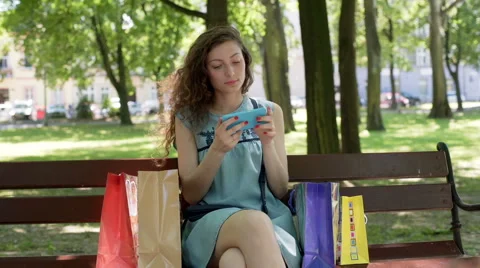 Happy girl browsing internet on smartphone and looking to the camera Stock-Footage 67564458