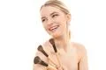 The happy girl with cosmetic brushes on the white background Photo