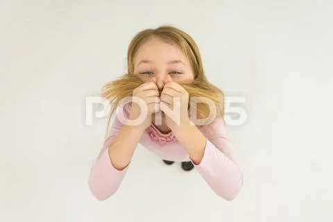 The happy girl gesture and hold her hair. View from above Stock Photos