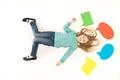 The happy girl gesture on the floor near the dialog signs. View from above Photo