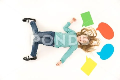 The happy girl gesture on the floor near the dialog signs. View from above Stock Photos