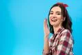 The happy girl gesturing on the blue background Photo