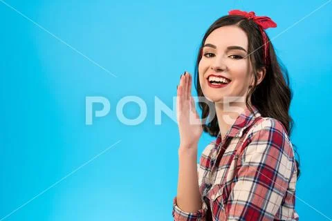 The happy girl gesturing on the blue background Stock Photos