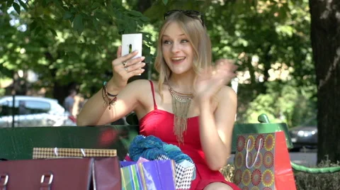 Happy girl having videocall and showing her purchase to someone Stock Footage