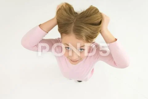 The happy girl hold her hair. View from above Stock Photos
