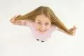 The happy girl hold her hair. View from above Photo