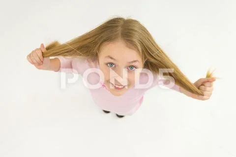 The happy girl hold her hair. View from above Stock Photos